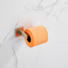 Brushed silver stainless steel toilet paper holder mounted on white marble wall with orange roll.