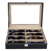 Black PU leather sunglasses case with 8 slots and clear acrylic lid, open to display various pairs.