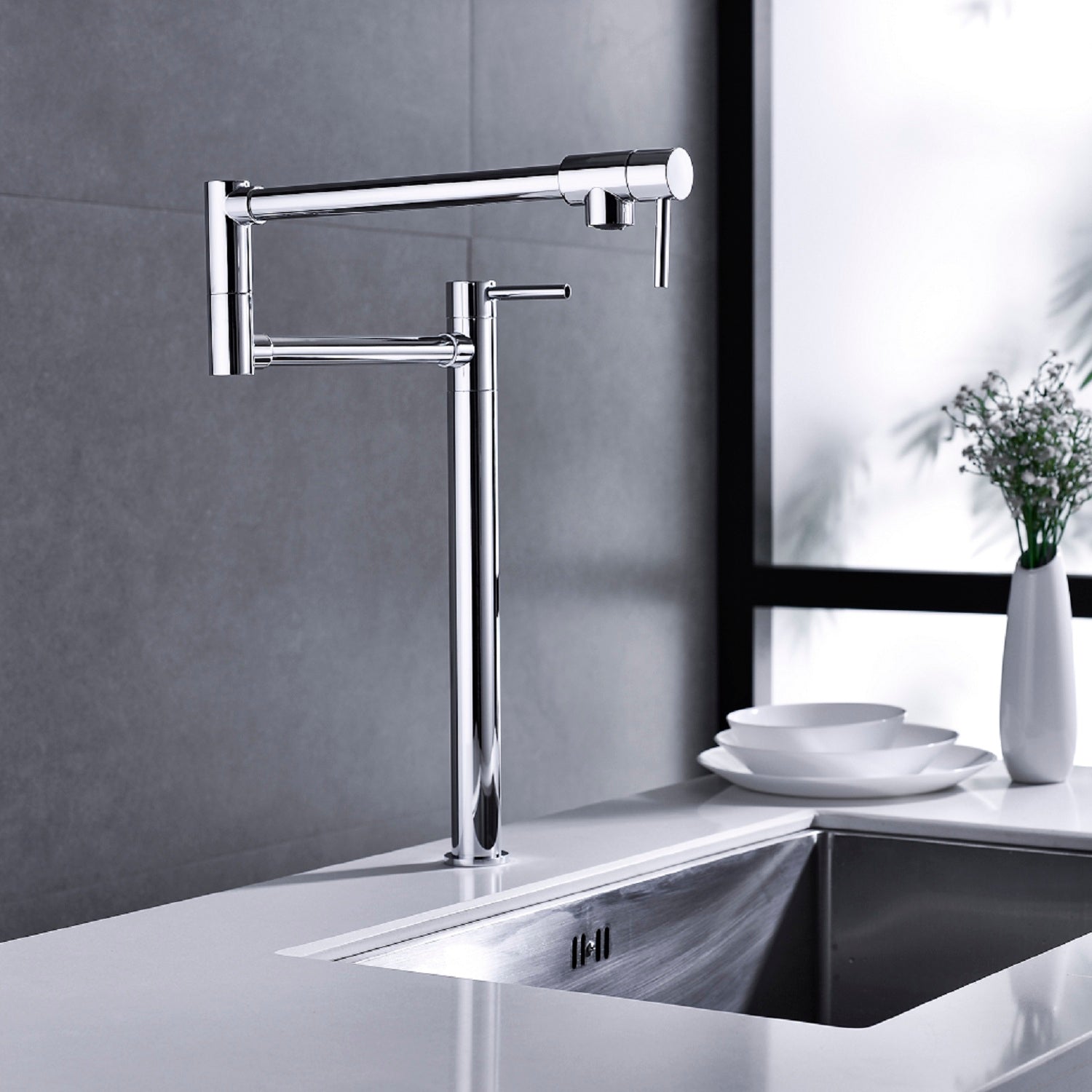 Brushed nickel two-handle brass pot filler faucet mounted on kitchen wall above sink.
