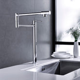 Brushed nickel two-handle brass pot filler faucet mounted on kitchen wall above sink.