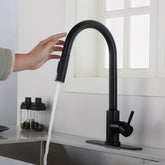 Matte black touchless kitchen faucet with pull-down sprayer, water flowing into sink.