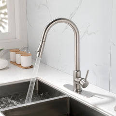 Stainless steel single-handle high-arc pull-down kitchen faucet with sprayer over a sink.
