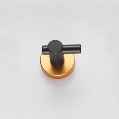 A single black wall hook with a round gold base is shown against a white background.