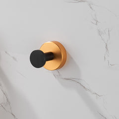 Black gold round base wall mount towel hooks, 4 pack, shown mounted on marble wall.