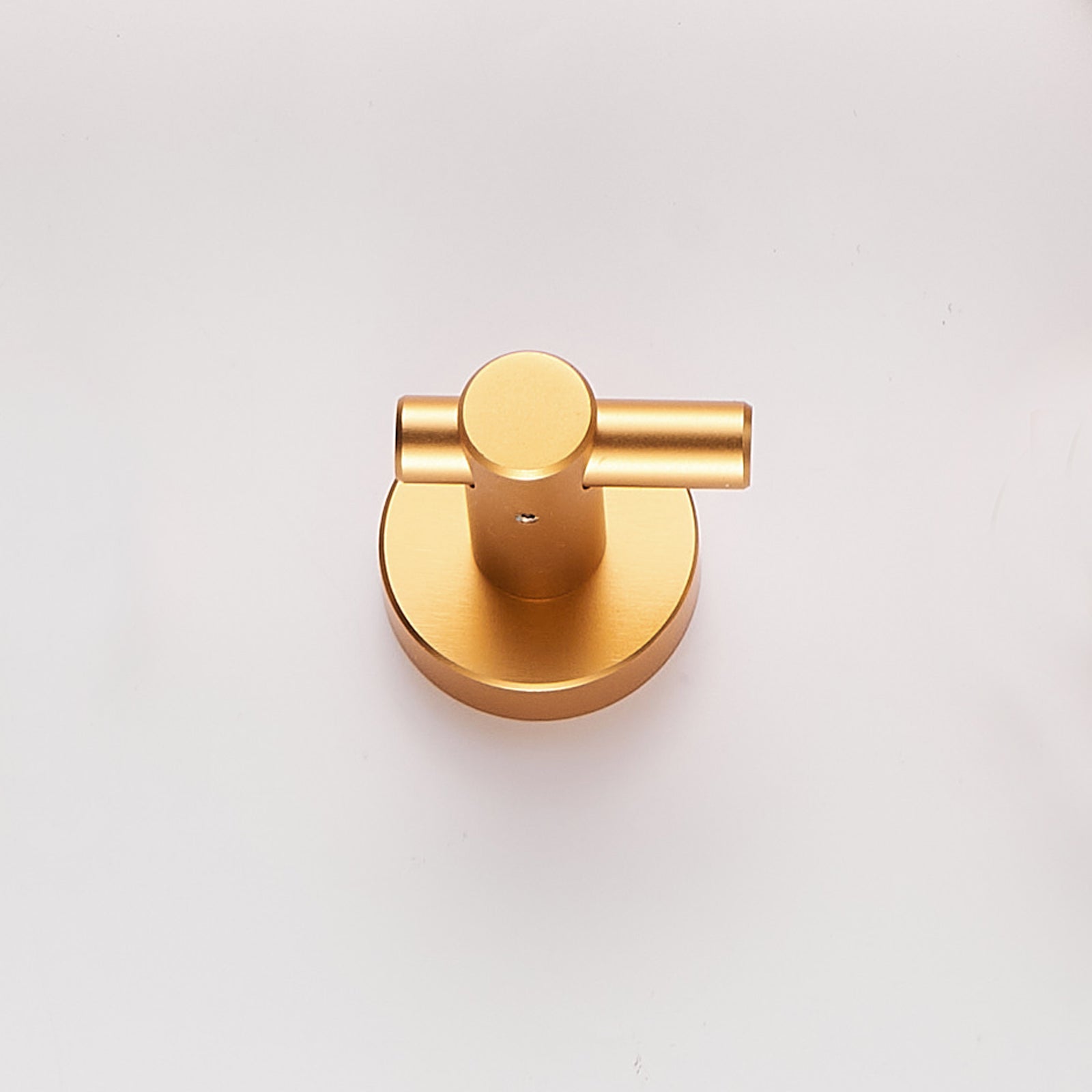 Brushed gold wall mount hook made of heavy duty aluminum, shown from above.