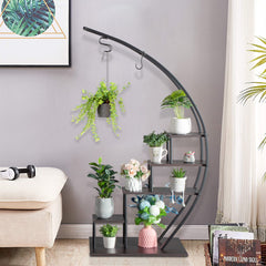 A black iron semicircle plant stand with five tiers displaying various potted plants and flowers.