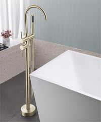 Brushed gold freestanding floor-mount bathtub faucet with curved spout next to white tub.