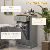 Gray kitchen cabinet with tilting trash bin door, drawer, and wood top.