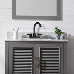 Matte black 2-handle centerset bathroom faucet with pop-up drain on a gray vanity.