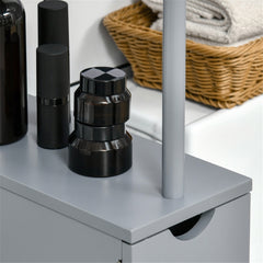 Slim grey bathroom storage cabinet with drawers and shelves on a counter with towels and bottles.