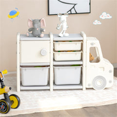 Gray HDPE truck-shaped kids toy storage organizer with drawers, bins, and stuffed animals on top.