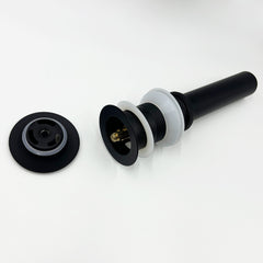 A black bathroom sink pop-up drain with overflow, disassembled on a white surface.