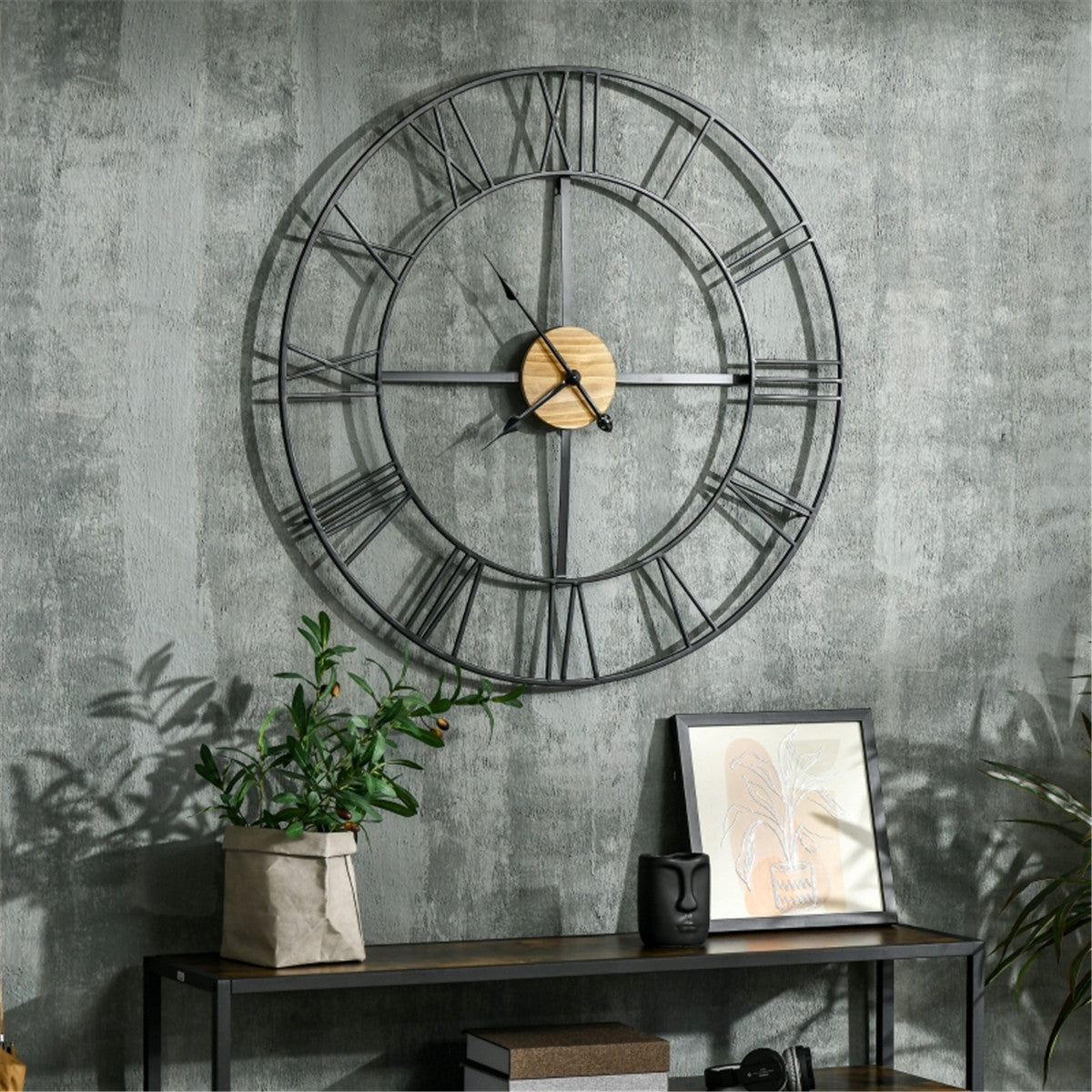 A 36-inch rustic wall clock with black metal frame, wood accents, and Roman numerals on a gray textured wall.