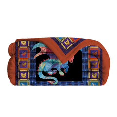 A folded flannel throw blanket with a colorful dragon print on a black background.
