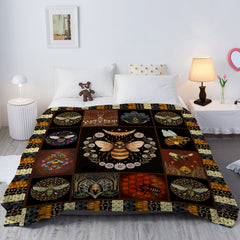 A 50x60 inch flannel velvet throw blanket with a central bee motif and floral patterns on a bed.