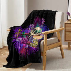 Black flannel throw blanket with vibrant mushroom and skull print, draped over a chair, 50x60 inches.