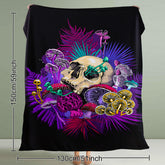 A black flannel throw blanket with a vibrant mushroom and skull print.