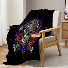 Black flannel throw blanket with 3D rose skull design draped over a chair.