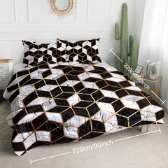 Queen-size 3-piece reversible comforter set in black, white, and gold geometric cube pattern.