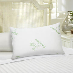 Two queen-size white bamboo pillows with green bamboo prints on a bed.