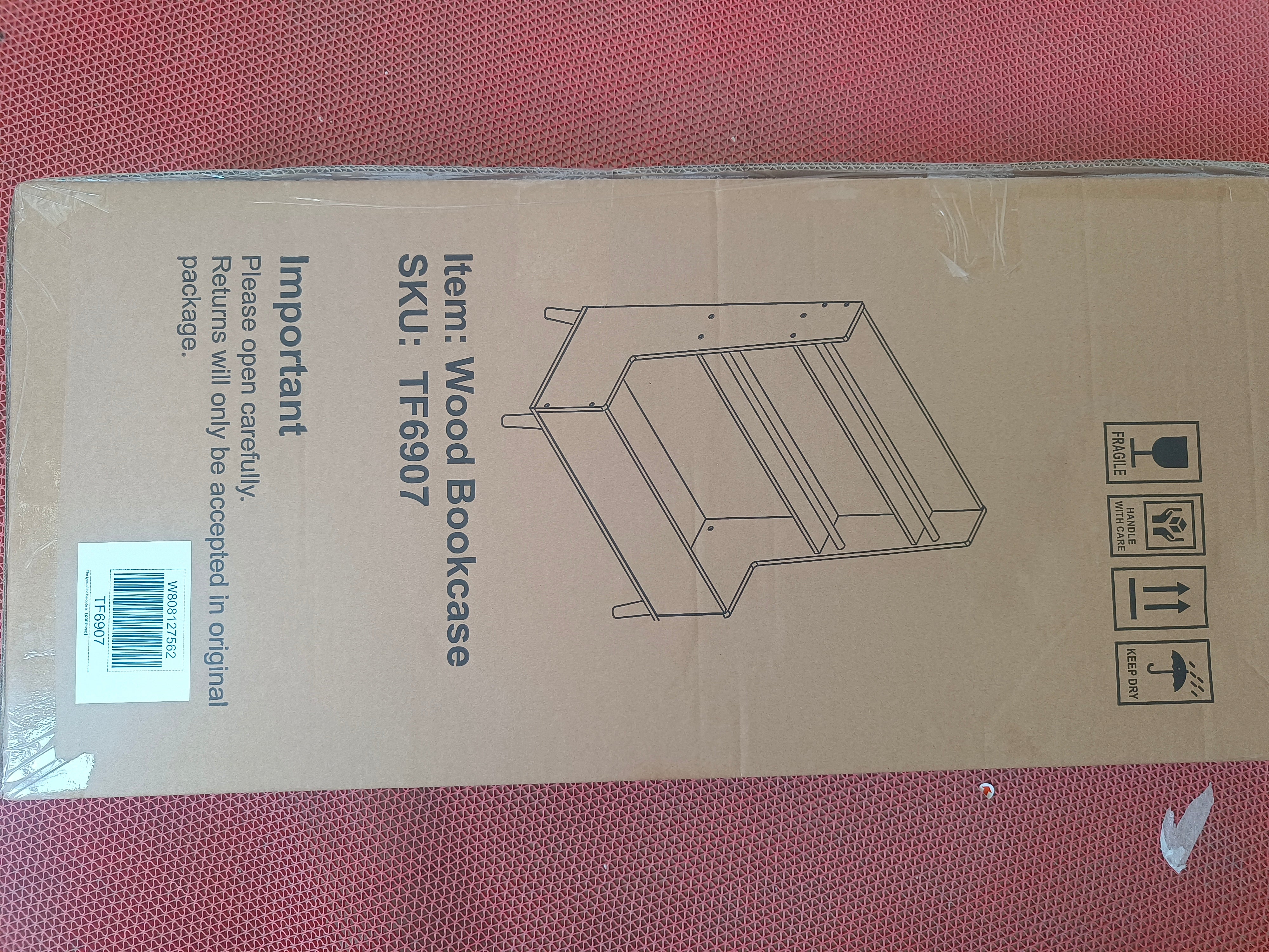 White MDF kids bookshelf with open shelves and toy storage bin on pine legs.