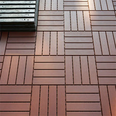 Dark brown plastic interlocking deck tiles are arranged in a checkerboard pattern.