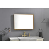 A 32x24 inch rectangular LED backlit bathroom mirror with wooden frame mounted above a white sink on a gray wall.