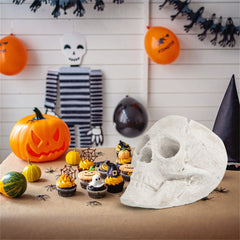 Beige ceramic skull for fire pits with realistic eye sockets and teeth for Halloween decor.