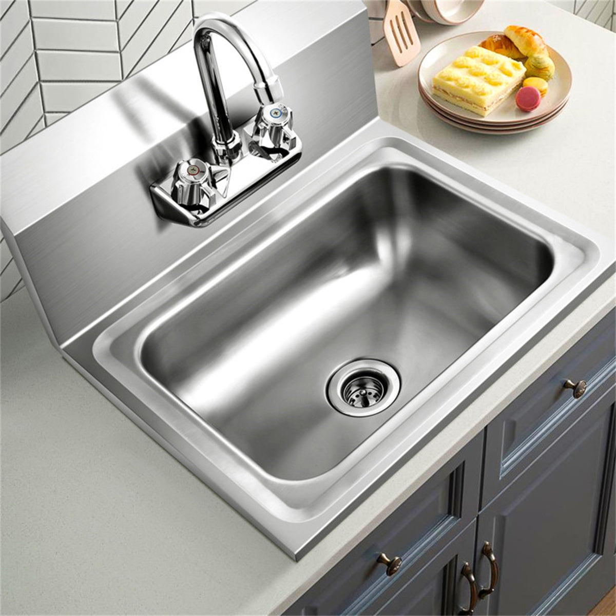 Stainless steel wall-mounted kitchen sink with gooseneck faucet, 17x15 inch bowl, and backsplash.