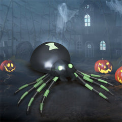 A 6-foot inflatable black spider with green striped legs and glowing eyes sits in a spooky yard.