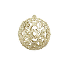 A gold glitter Christmas ornament with an intricate filigree design.