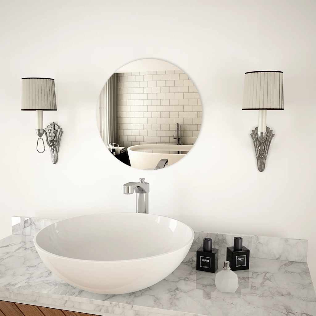 A 15.7-inch round glass wall mirror mounted above a white sink in a modern bathroom.