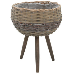 Brown wicker planter on wooden tripod legs with PE lining.
