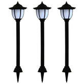 Three black LED solar garden stake lights with white lanterns and ground stakes.