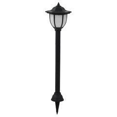 Black LED solar garden stake light with white frosted panels and pointed base.
