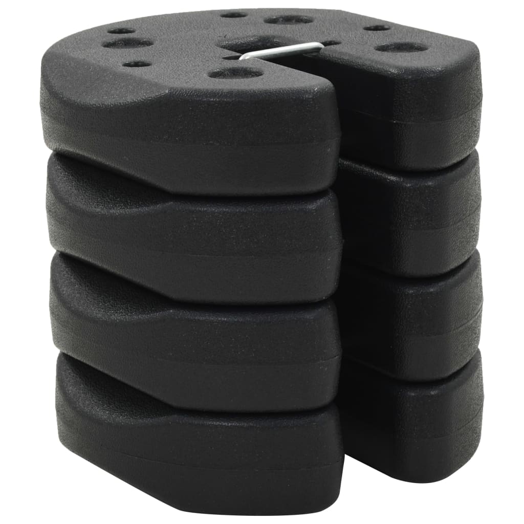 Four black, interlocking gazebo weight plates are stacked on a white background.