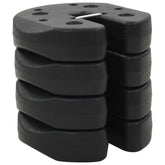 Four black, interlocking gazebo weight plates are stacked on a white background.
