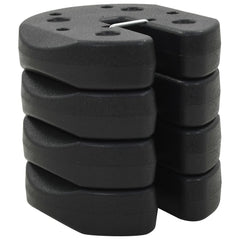 Four black, interlocking gazebo weight plates are stacked on a white background.