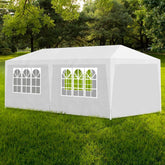 White 10'x20' party tent with steel frame, arched window panels, and zippered door on green grass.