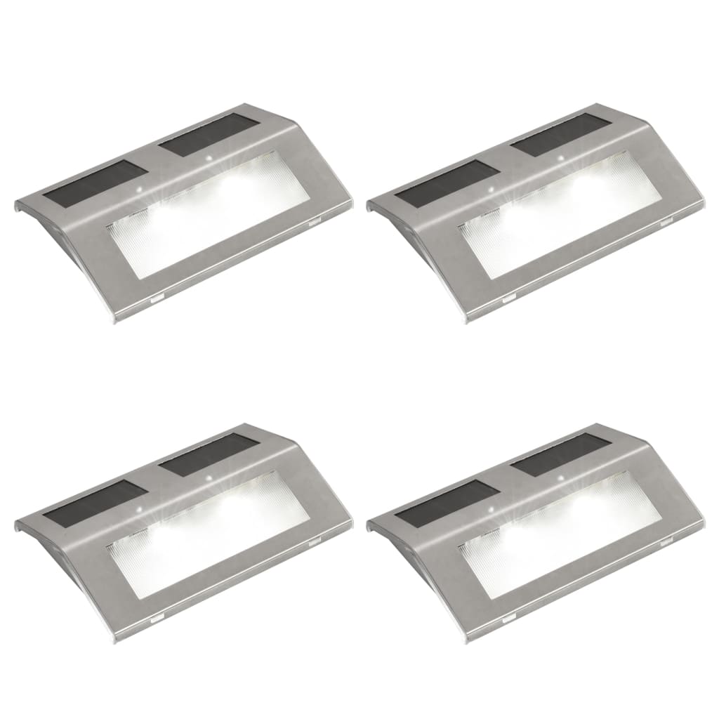 Four stainless steel solar-powered stair lights with integrated panels and LED glow.