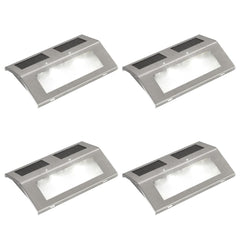 Four stainless steel solar-powered stair lights with integrated panels and LED glow.