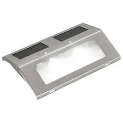 Four stainless steel solar-powered stair lights with integrated panels and LED glow.