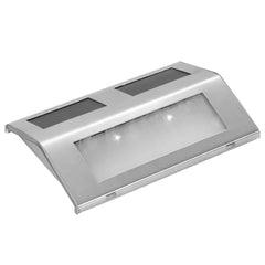Four stainless steel solar-powered stair lights with integrated panels and LED glow.