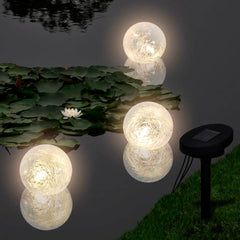 Three solar LED floating ball lights in white, designed for pond and pool decoration.