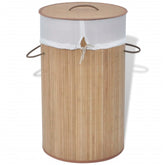 Natural bamboo round laundry hamper with removable liner and built-in handles.