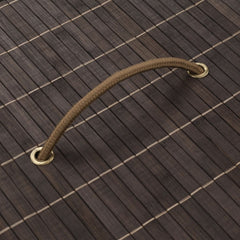 Dark brown oval bamboo laundry hamper with removable liner and sturdy handles.