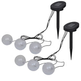 Two sets of three white solar LED ball lights with black ground spikes.