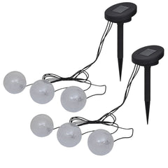 Two sets of three white solar LED ball lights with black ground spikes.