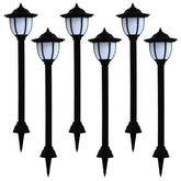 Six black LED solar garden lamps with stakes and glowing lanterns.