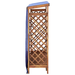 Wooden firewood storage shed with sloped blue tarp roof and lattice sides.